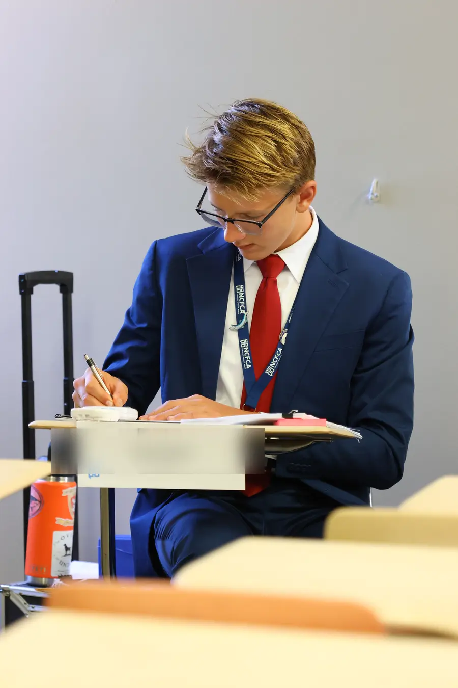 Wavemakers student at an NCFCA tournament debate table